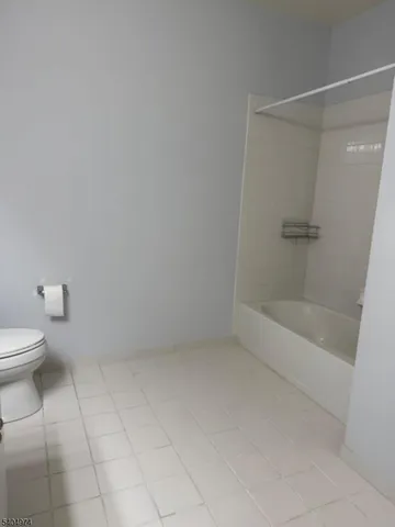 a bathroom with a toilet and shower