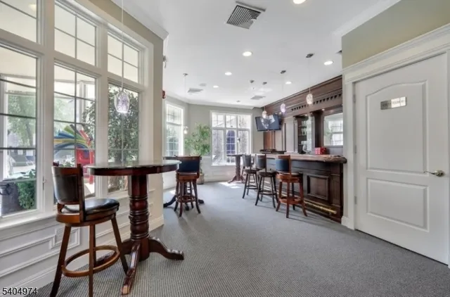 a view of a a dining room with furniture window and outside view