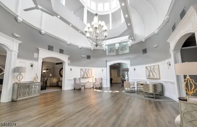 a view of a big room with chandelier and wooden floor
