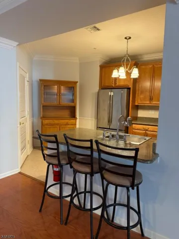a view of a dining room with furniture and chandelier