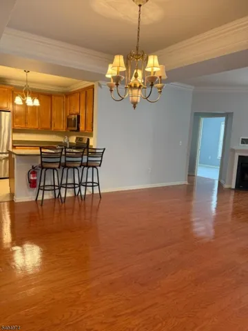 a view of a dining room with furniture wooden floor and chandelier