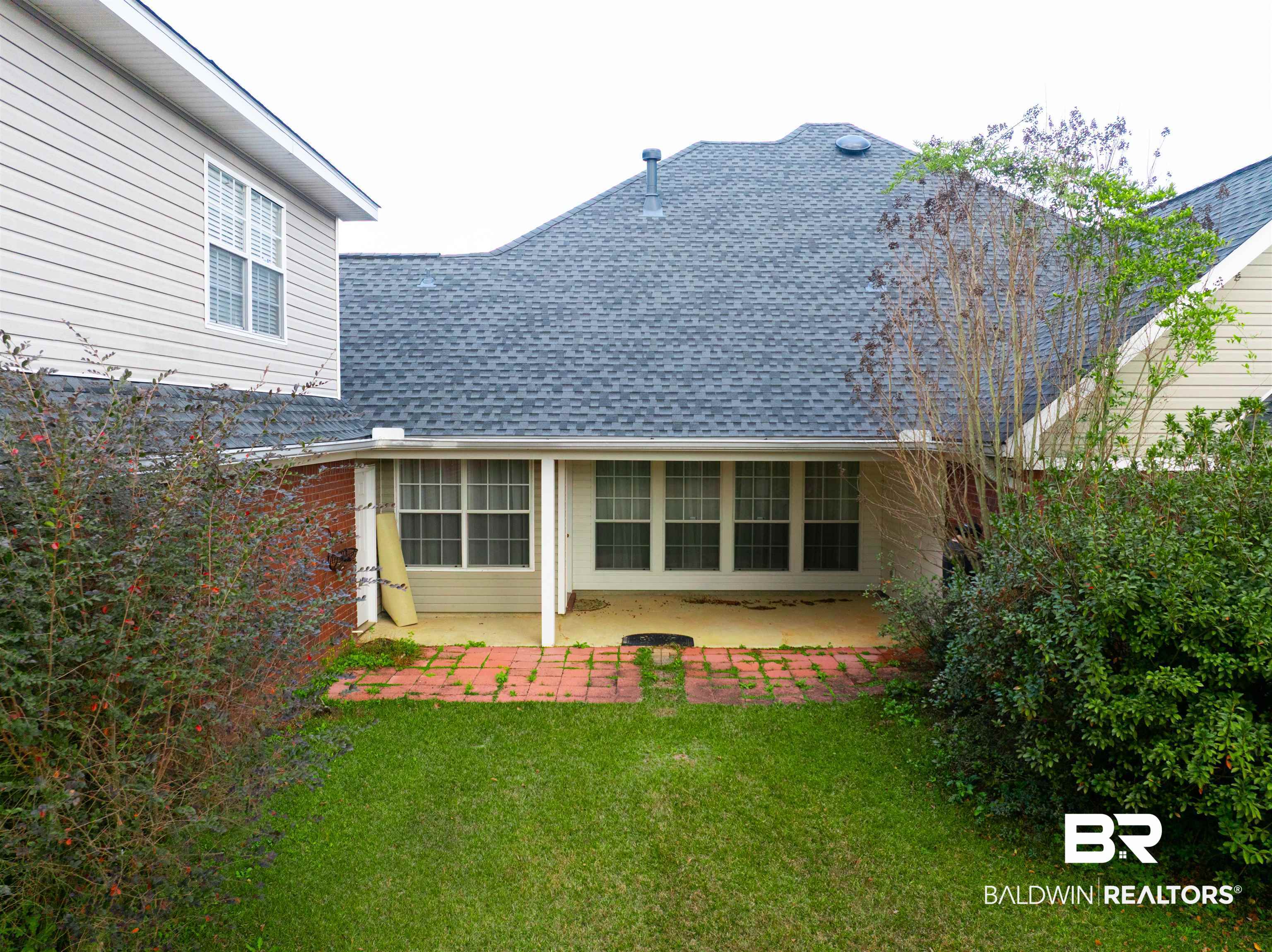 10023 Springfield Court Mobile, AL 36695 - Photo 4 of 50 Rear view of property featuring a lawn, a patio, and roof with shingles