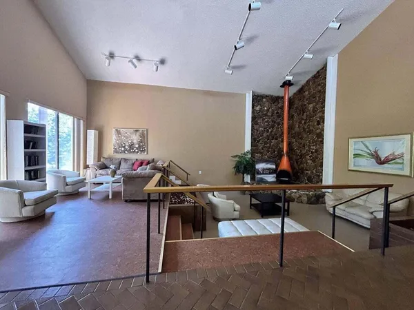 a room with pool table and windows