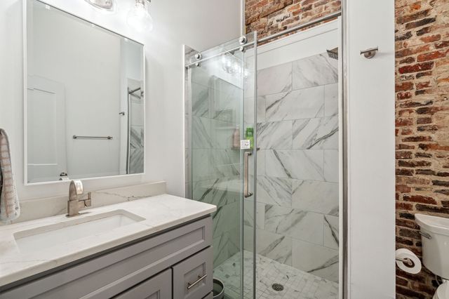 a kitchen with stainless steel appliances granite countertop a sink and a refrigerator