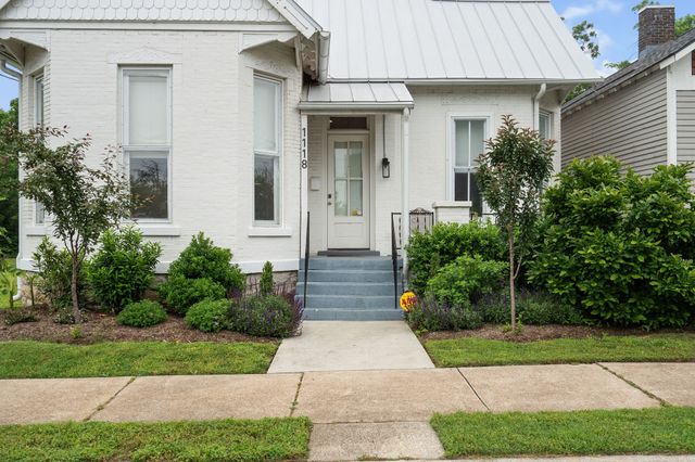 a front view of a house with garden