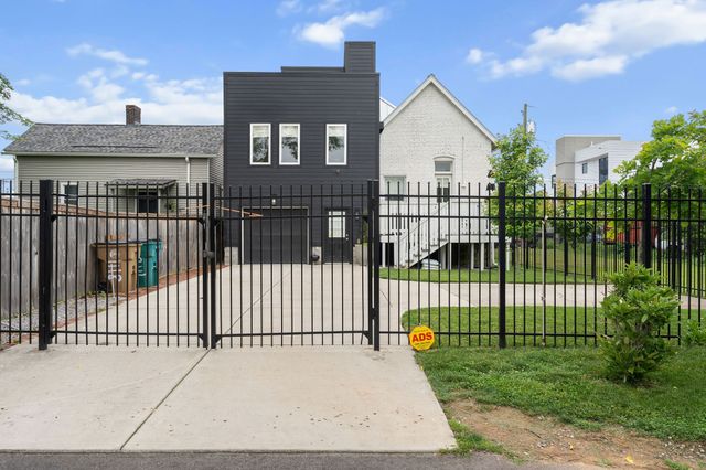 an aerial view of a city with lots of residential buildings ocean and mountain view in back