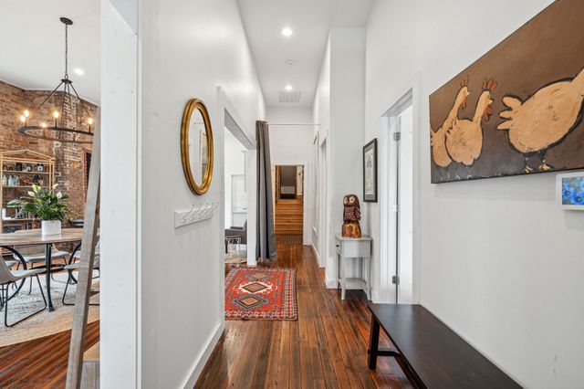 a view of a livingroom with furniture and hardwood floor