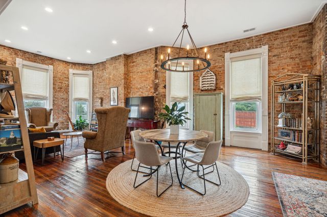 a living room with furniture fireplace and a flat screen tv