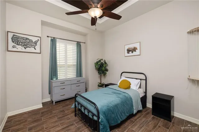a bathroom with a granite countertop sink toilet and mirror