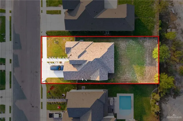 an aerial view of a house with a yard