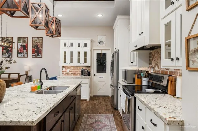 a kitchen with a sink stove and refrigerator