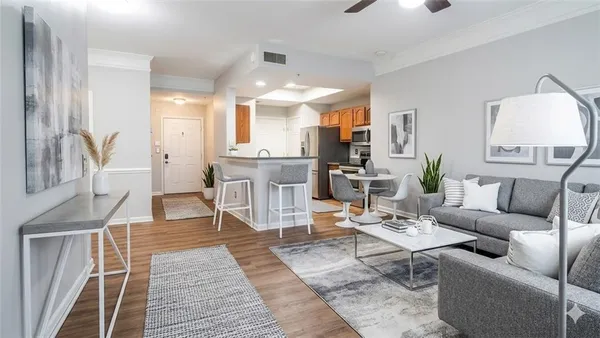 a living room with furniture a rug and a chandelier