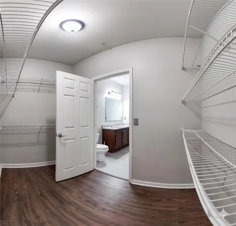 a room with wooden floor and white walls