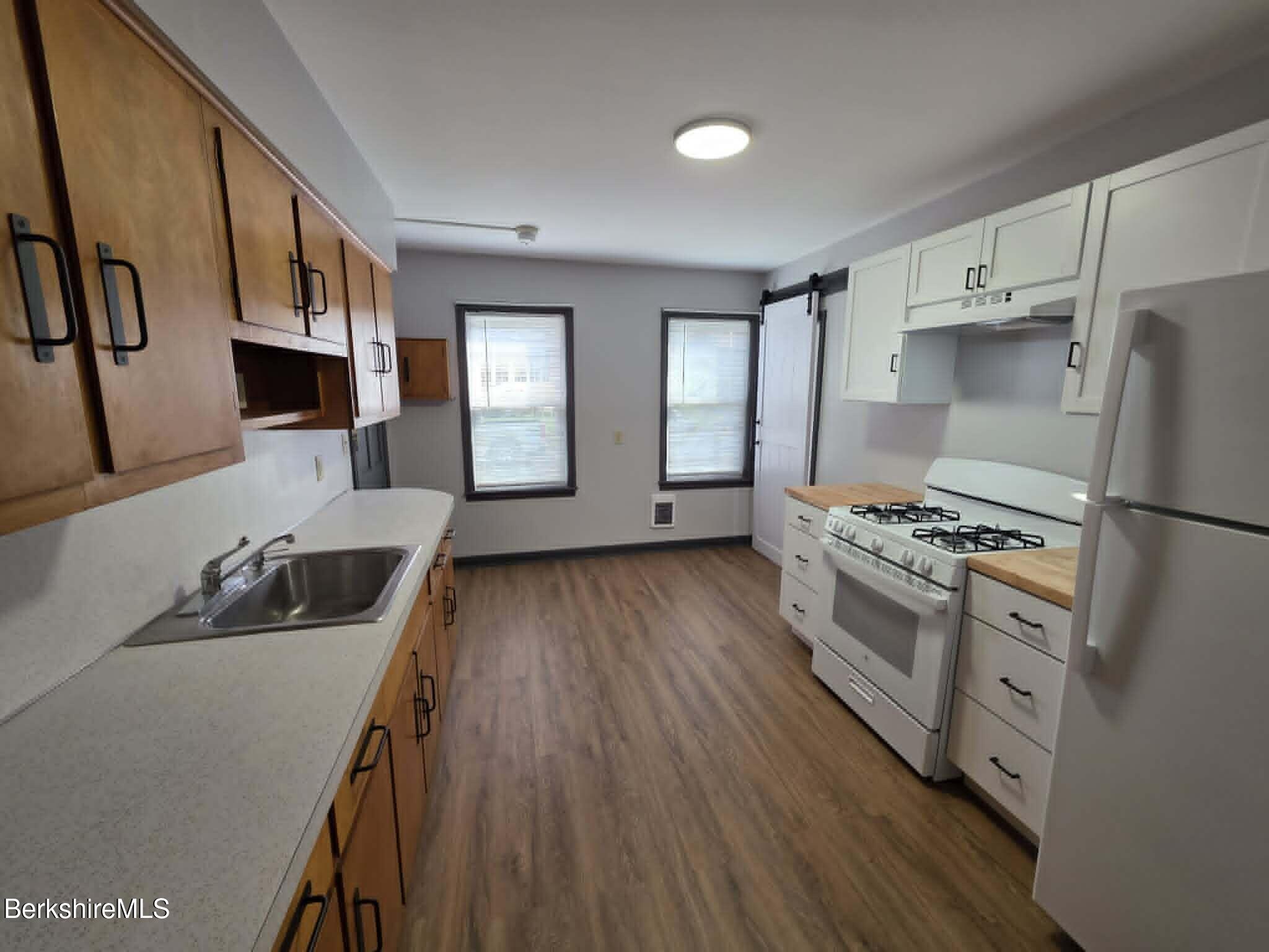 40 East Jordan Street, Unit 1 Adams, MA 01220 - Photo 1 of 12 a kitchen with stainless steel appliances granite countertop a refrigerator a stove and a wooden floors