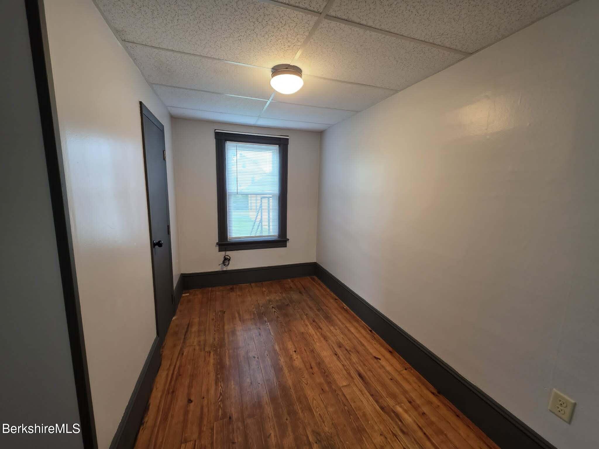 40 East Jordan Street, Unit 1 Adams, MA 01220 - Photo 5 of 12 wooden floor in an empty room with a window
