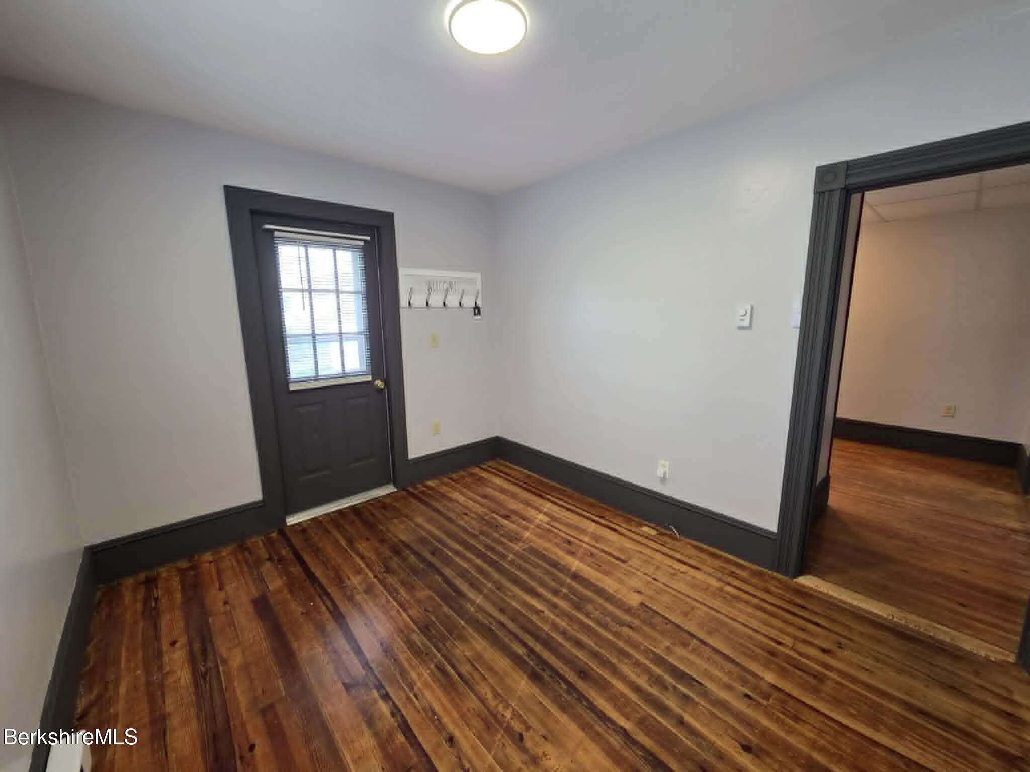 40 East Jordan Street, Unit 1 Adams, MA 01220 - Photo 6 of 12 a view of empty room with wooden floor and fan