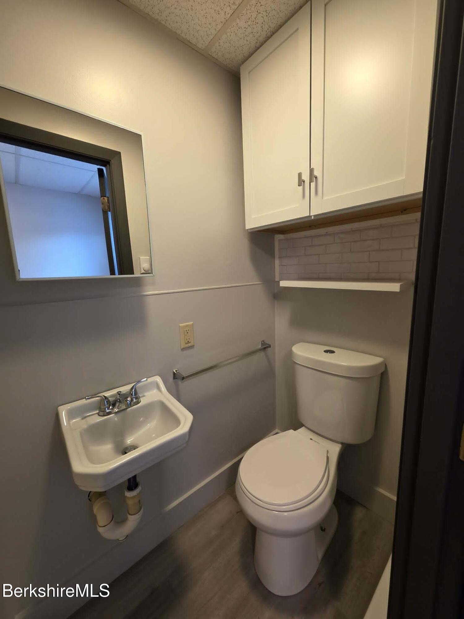 40 East Jordan Street, Unit 1 Adams, MA 01220 - Photo 10 of 12 a bathroom with a toilet a sink and mirror