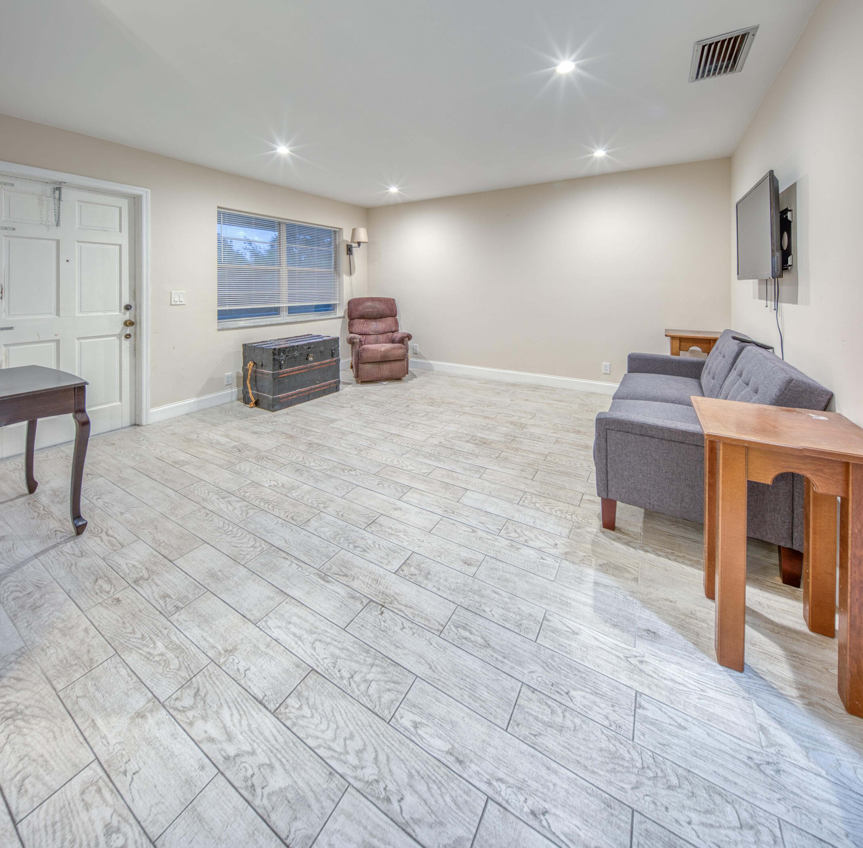 301 South Lakeside Drive, Unit 7 Lake Worth Beach, FL 33460 - Photo 7 of 15 a living room with furniture and a fireplace