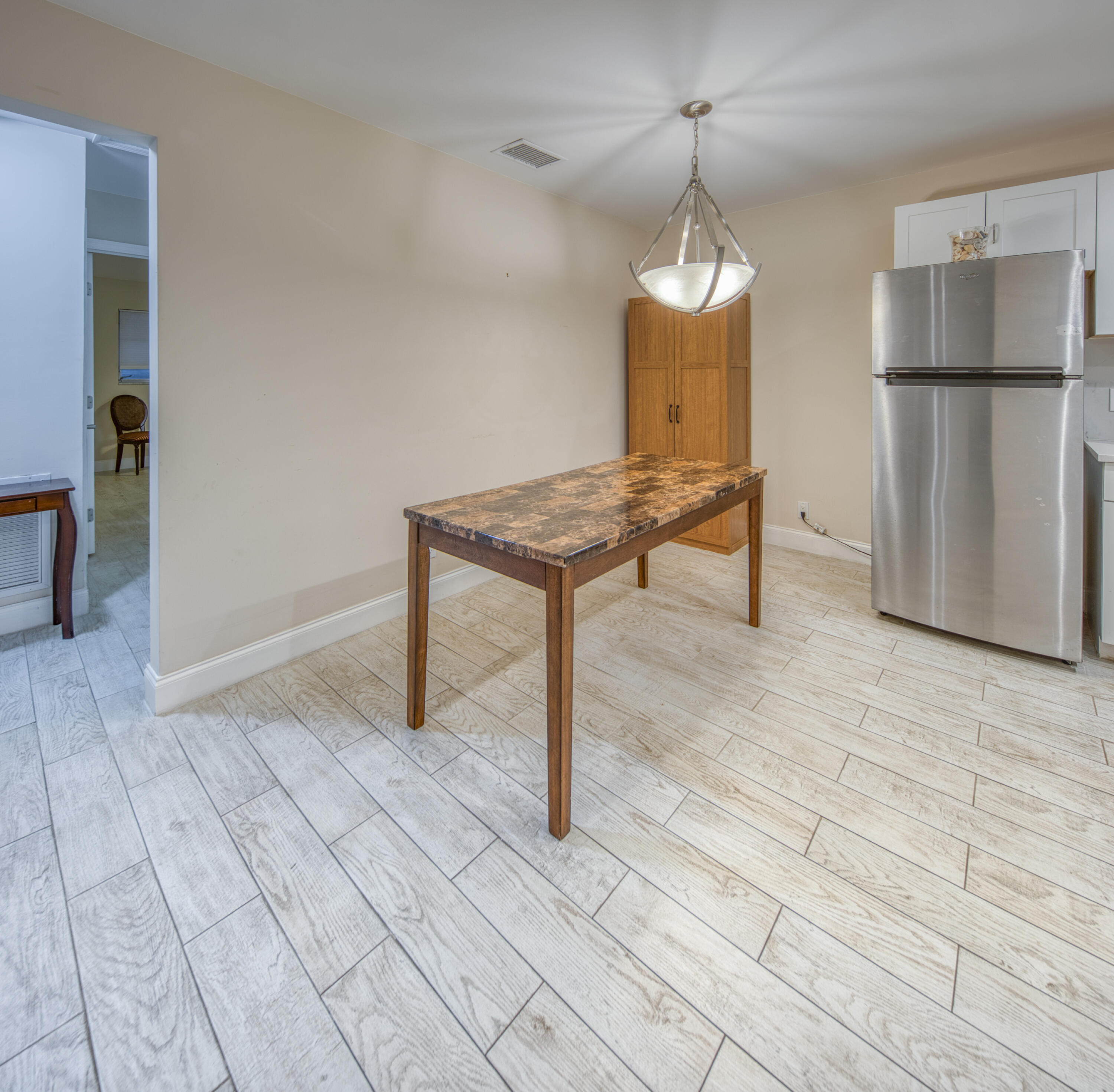 301 South Lakeside Drive, Unit 7 Lake Worth Beach, FL 33460 - Photo 8 of 15 a view of a room with wooden floor and cabinet