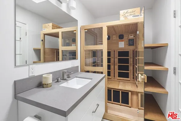 a kitchen with a sink and a mirror