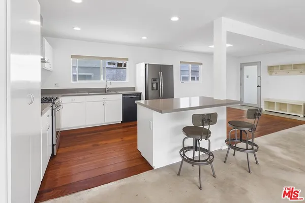 a large kitchen with a table and chairs