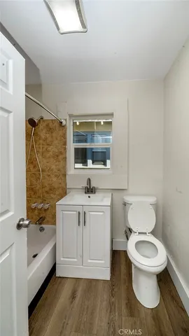 a bathroom with a toilet a sink and bathtub