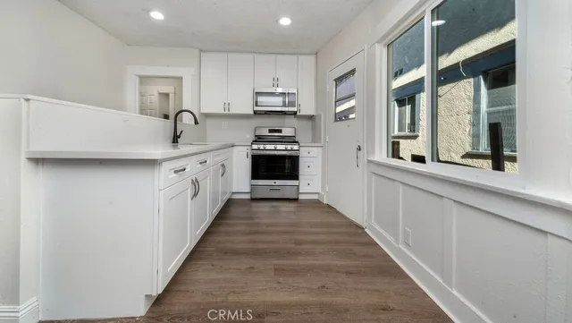 a kitchen with stainless steel appliances a sink and cabinets