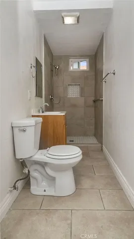a bathroom with a toilet a sink and a shower
