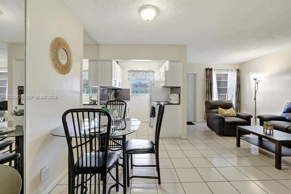 a view of a dining room with furniture and a window