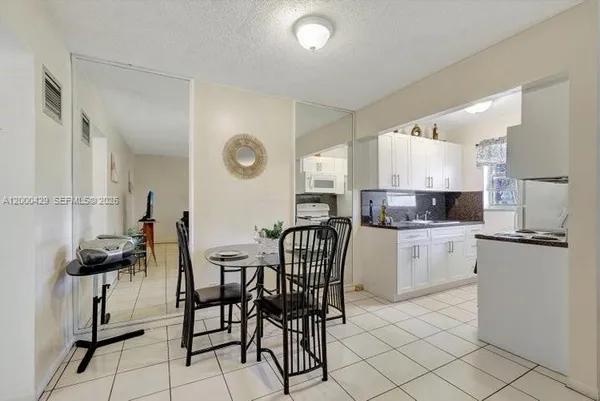a kitchen with a sink cabinets and window