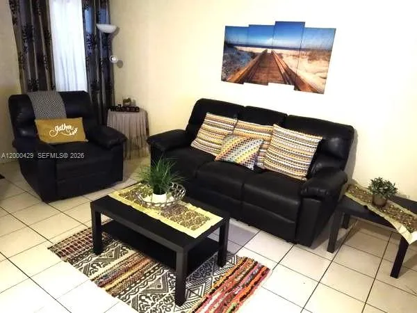 a living room with furniture and a lamp