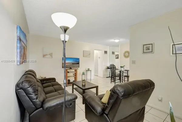 a living room with furniture a couch and a chandelier