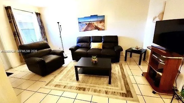 a living room with furniture and a flat screen tv