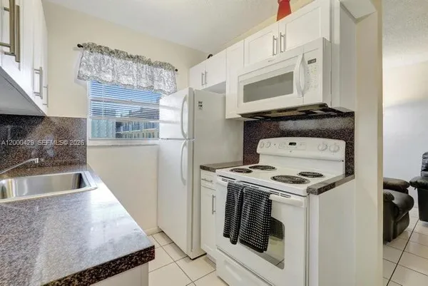 a kitchen with a stove and a microwave