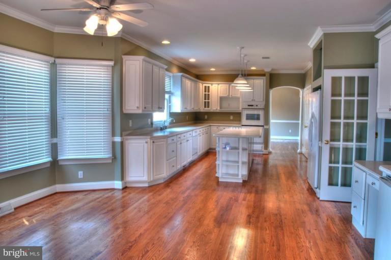13925 Sunnybrook Road Phoenix, MD 21131 - Photo 3 of 30 a kitchen with stainless steel appliances granite countertop wooden floors and window