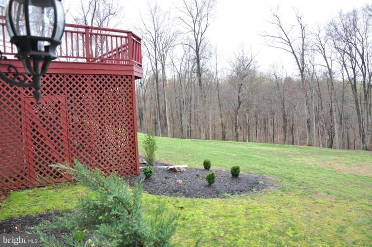 13925 Sunnybrook Road Phoenix, MD 21131 - Photo 28 of 30 a view of a backyard with plants and wooden fence