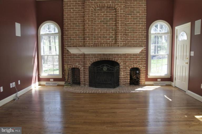 13925 Sunnybrook Road Phoenix, MD 21131 - Photo 6 of 30 a view of a livingroom with a fireplace window and wooden floor