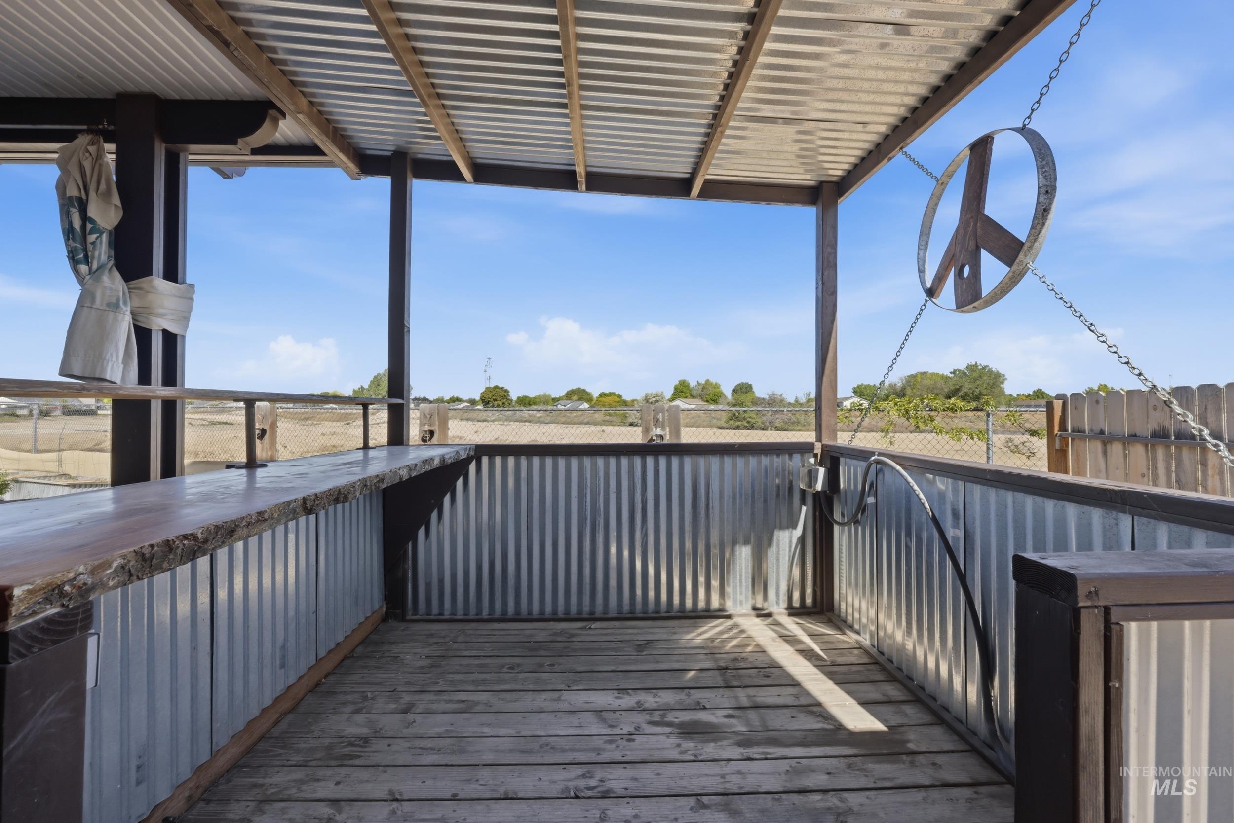 4855 South Chex Way Boise, ID 83709 - Photo 36 of 47 Covered patio with a corrugated metal roof and wood-finish flooring