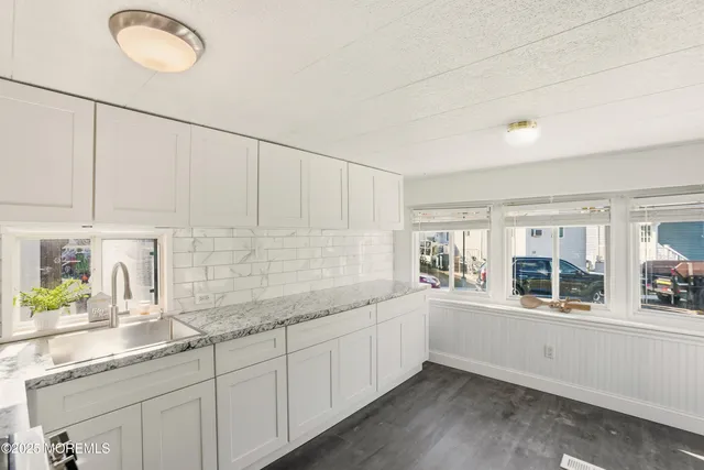 a kitchen with sink and cabinets