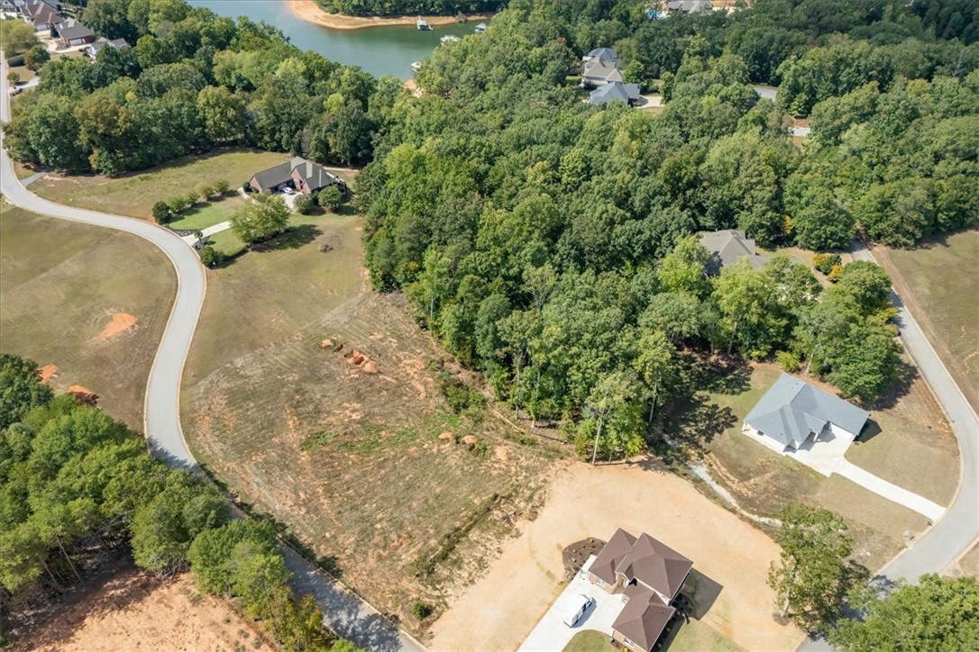 106 C-4-112A Anderson, SC 29625 - Photo 14 of 20 Aerial view of a sprawling property with a tranquil lake nearby, offering ample space and natural beauty.