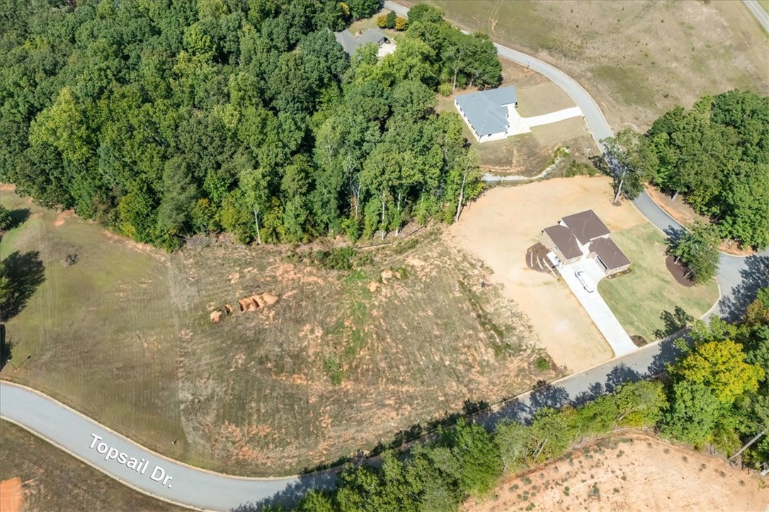 106 C-4-112A Anderson, SC 29625 - Photo 7 of 20 This aerial view showcases a residential lot nestled among lush green trees, perfect for a new home.