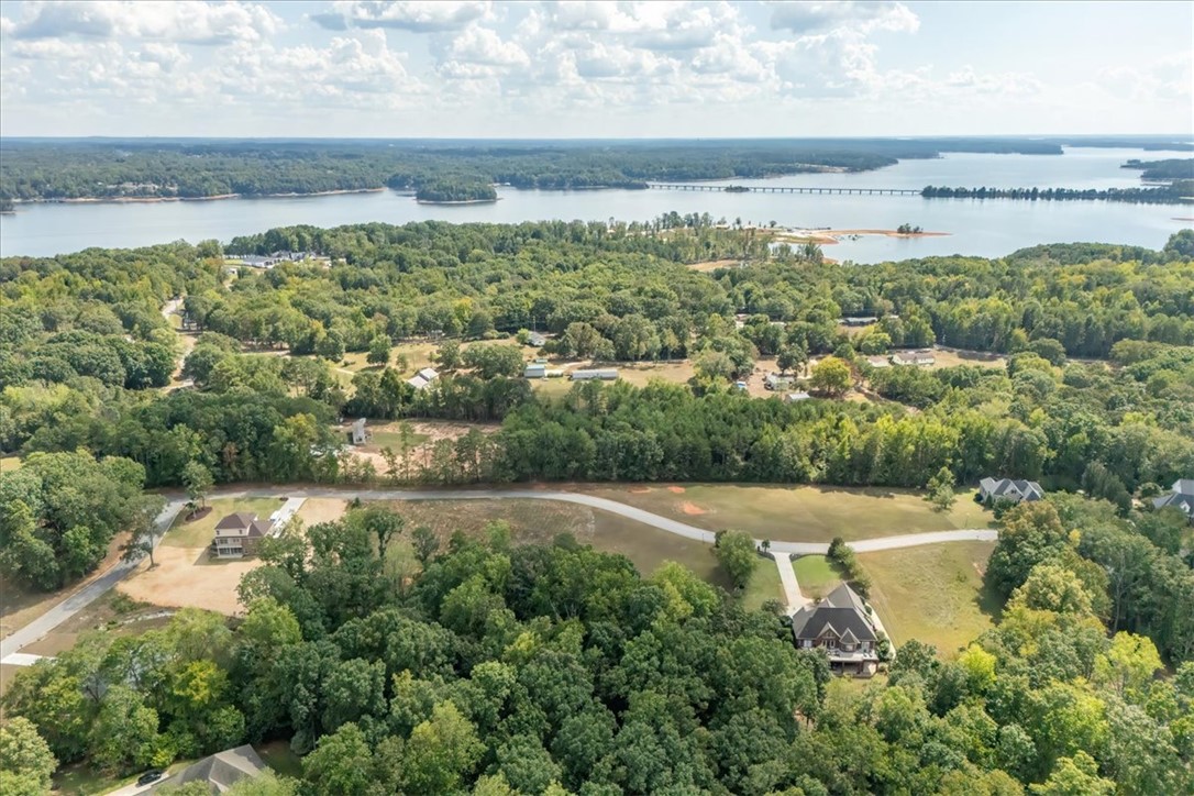 106 C-4-112A Anderson, SC 29625 - Photo 10 of 20 This elevated view captures the expansive lake, serene woodlands, and a charming home.
