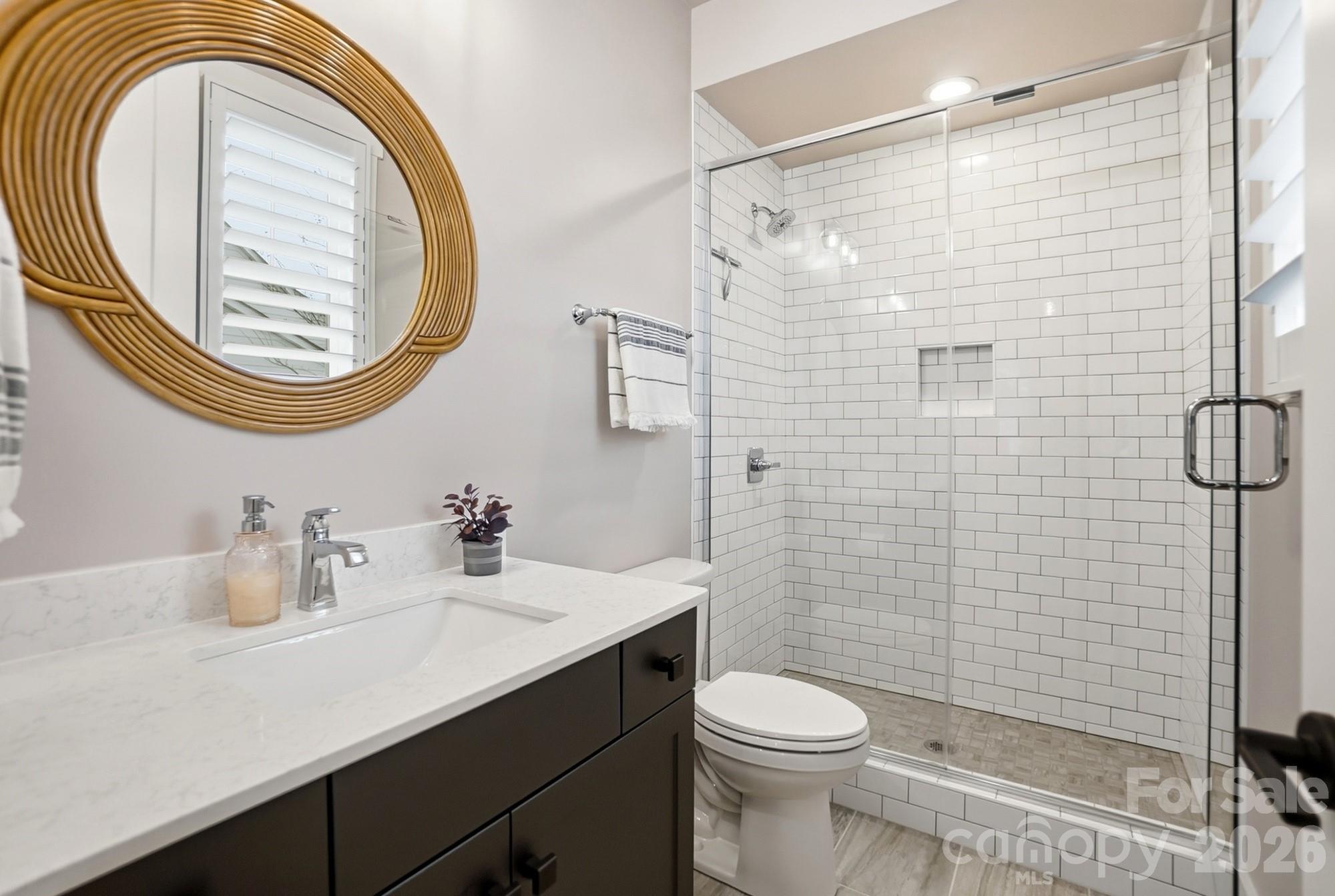 2052 Thatcher Way Fort Mill, SC 29715 - Photo 25 of 47 a bathroom with a sink a mirror a toilet and shower