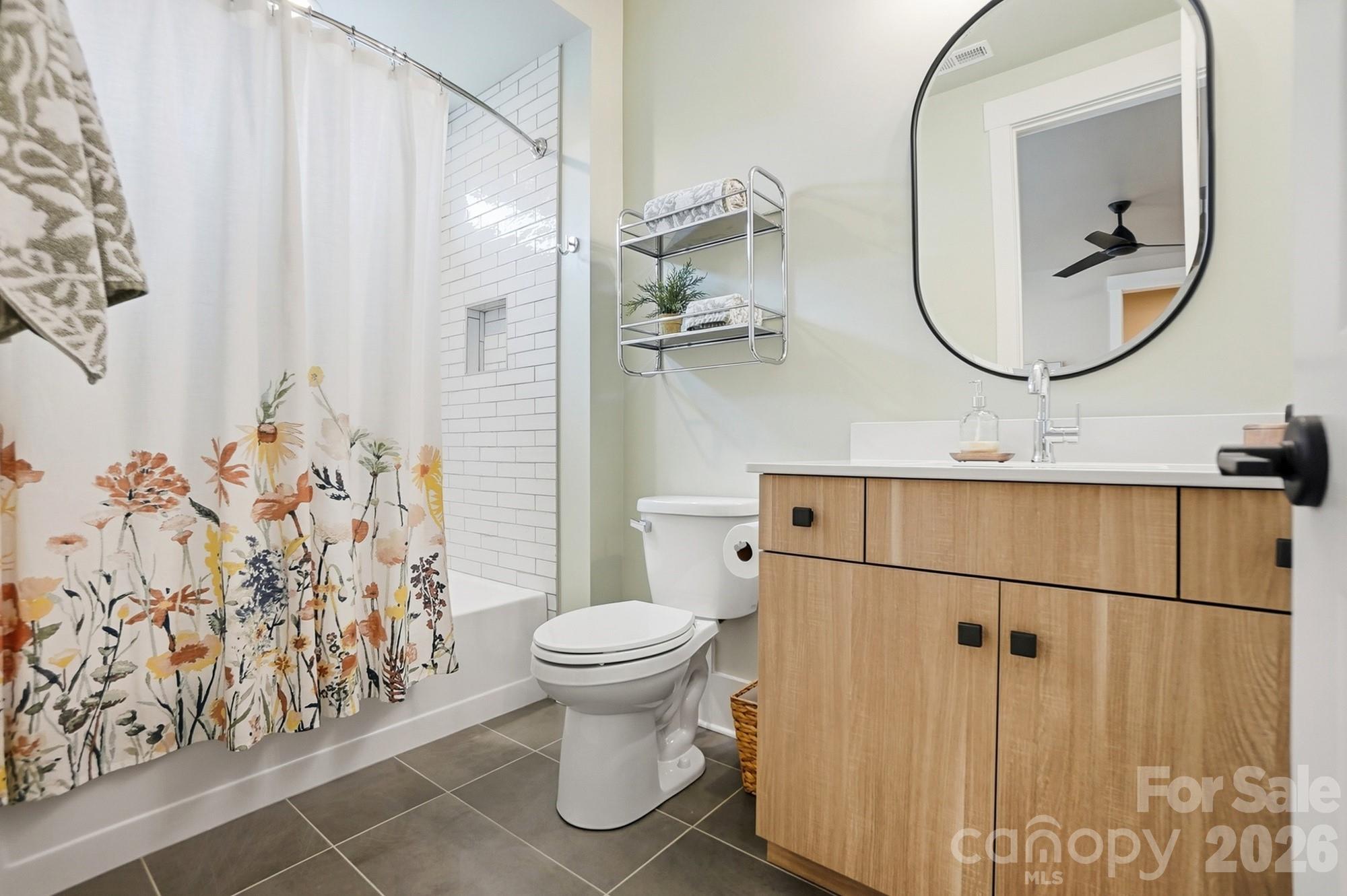 2052 Thatcher Way Fort Mill, SC 29715 - Photo 39 of 47 a bathroom with a shower curtain and a mirror