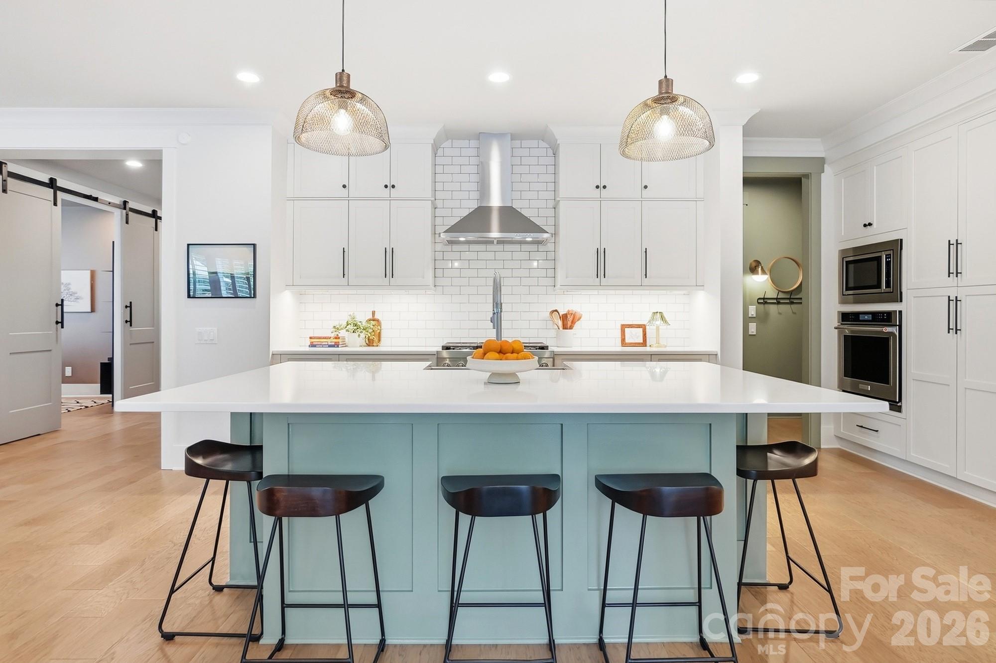 2052 Thatcher Way Fort Mill, SC 29715 - Photo 7 of 47 a kitchen with stainless steel appliances a dining table chairs sink and cabinets