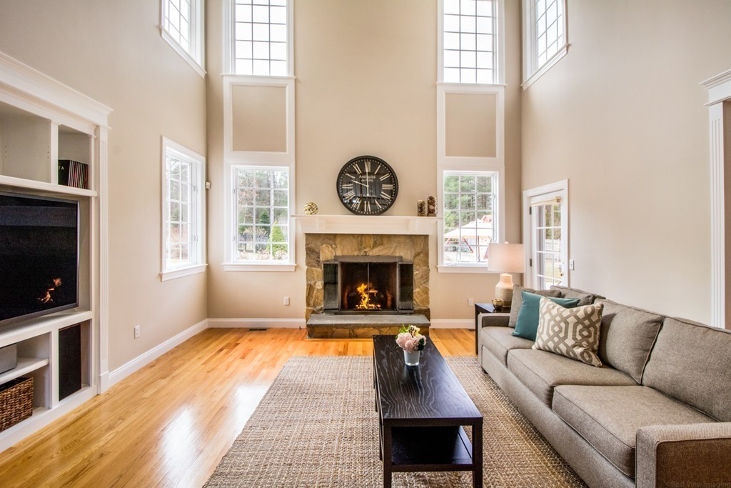 49 Amanda Road Sudbury, MA 01776 - Photo 12 of 30 a living room with furniture a flat screen tv and a fireplace