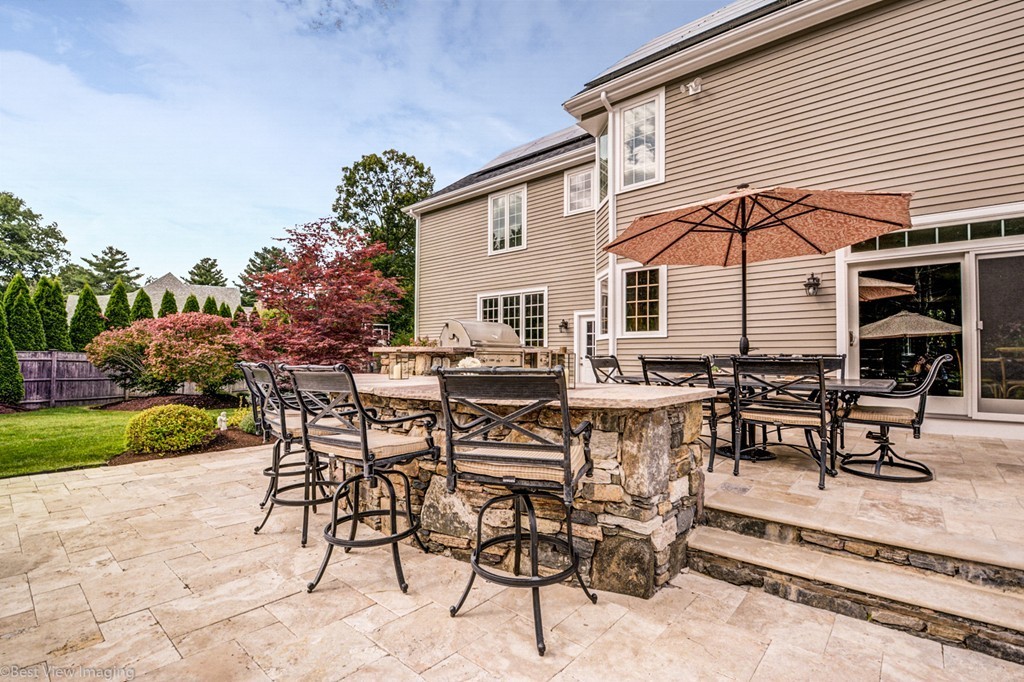 49 Amanda Road Sudbury, MA 01776 - Photo 27 of 30 a view of a dinning table and chairs in patio of the house