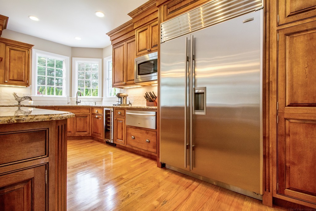 49 Amanda Road Sudbury, MA 01776 - Photo 9 of 30 a kitchen with stainless steel appliances granite countertop a refrigerator and a sink