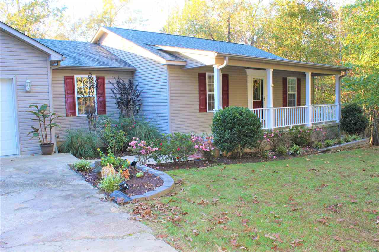 1012 Greenway Road Huron, TN 38345 - Photo 1 of 1 a front view of a house with a yard and a garden