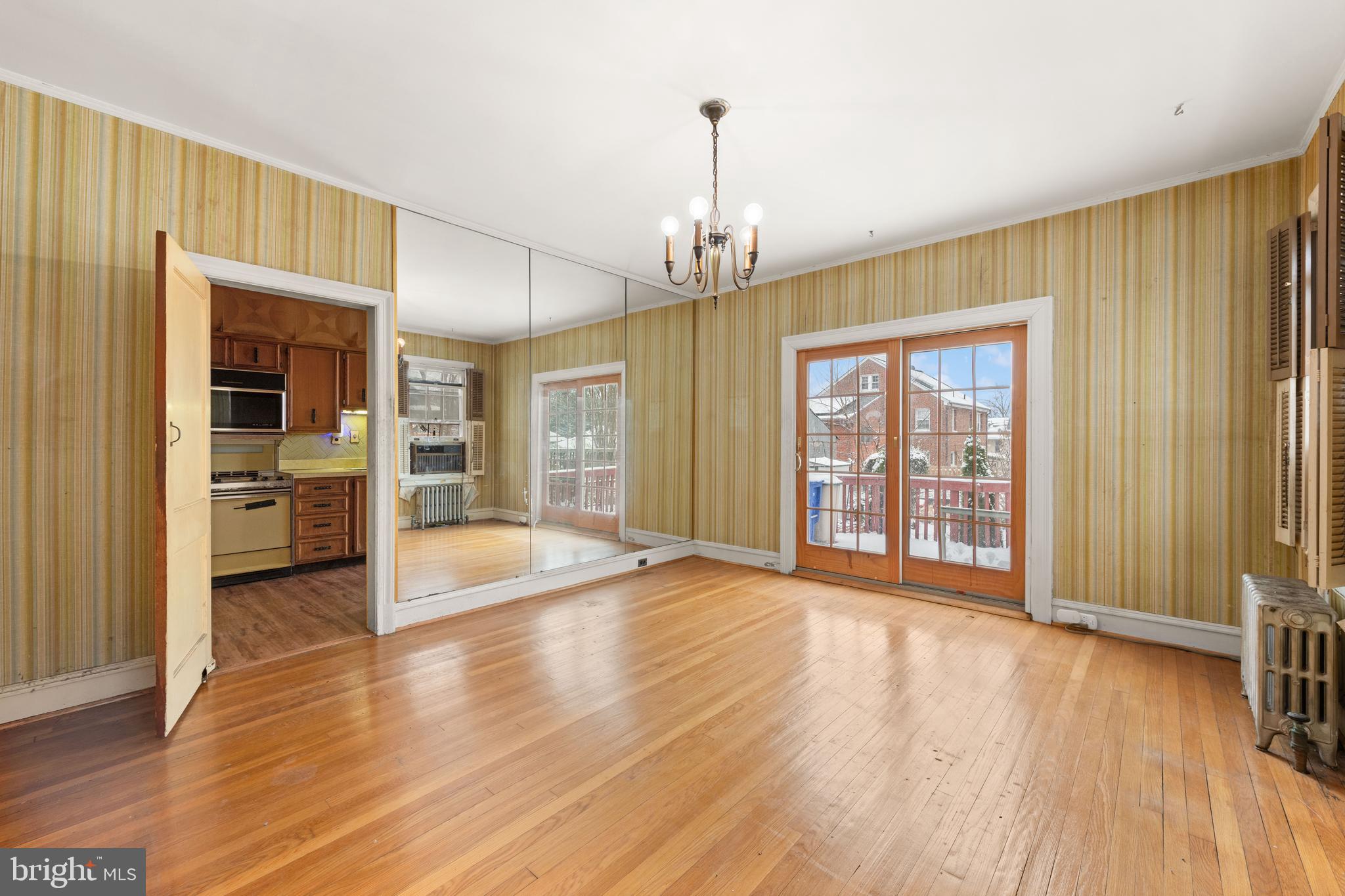 1702 Webster Street Northwest Washington, DC 20011 - Photo 11 of 42 a view of an empty room with window and wooden floor